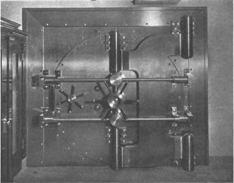 Vault with door closed showing combination locks and crane hinge