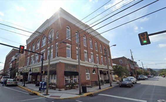 The old Farmers National Bank of Bedford, Pennsylvania, located on the corner of Pitt and Juliana Streets, ca2023. The bank's entrance is at the right where Indiana limestone was used on the exterior.