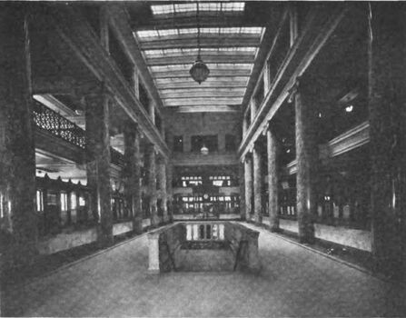 Main banking room showing the stairs leading to safe deposit vaults, ca1923.