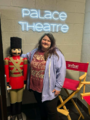 Rachel standing in front of The Palace Theatre sign