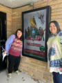 Rachel and Missy standing outside of The Palace Theatre by the movie they watched "The Best Christmas Pageant Ever"