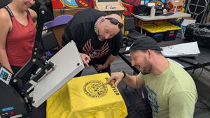 Silly makers looking at a t-shirt made with a DTF transfer