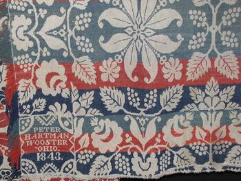 Image showing a portion of a coverlet designed and weaved by Peter Hartman that is part of the Wayne County Historical Society of Ohio collections.